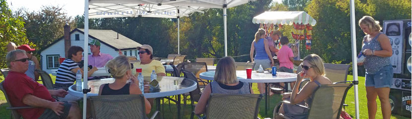 BBQ Party in a Box barbequeing up a dinner for a family birthday party in the shade of our tents